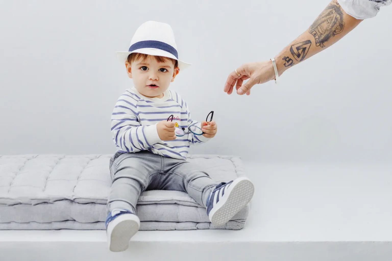 a baby sitting on a pillow