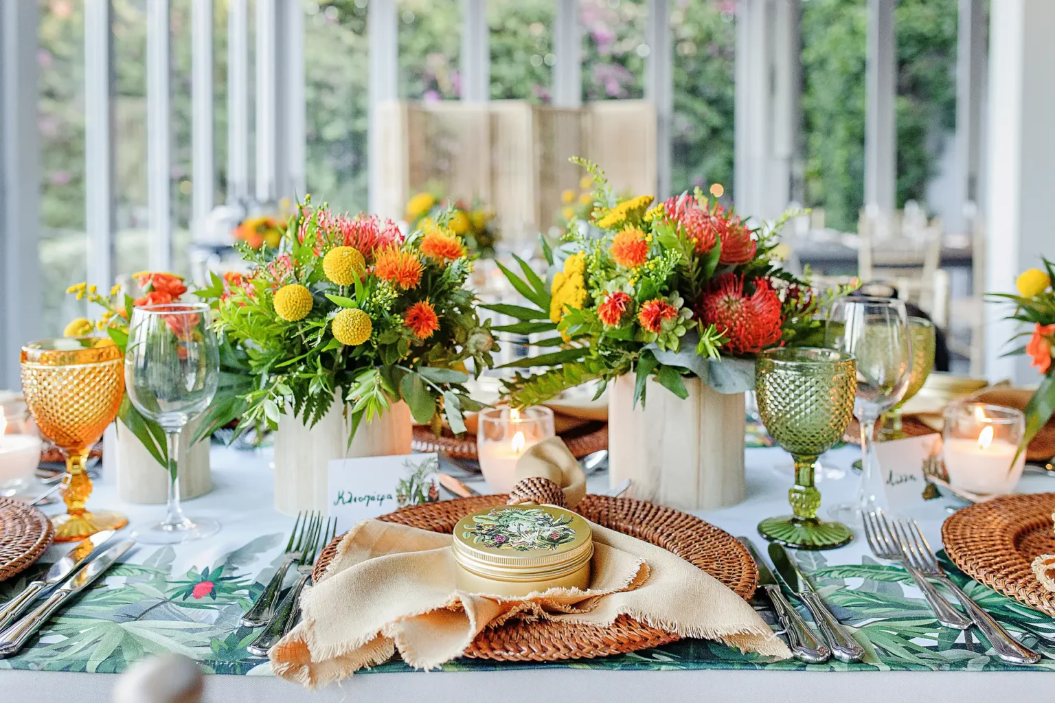 a table set with flowers and glasses
