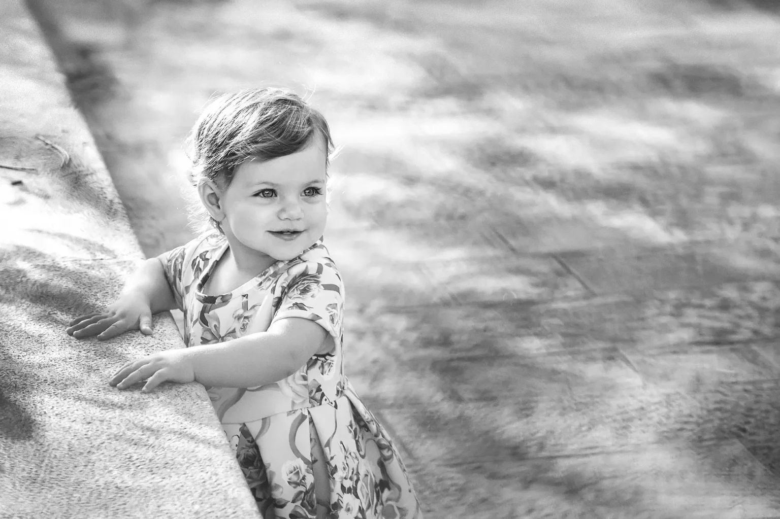 a child leaning on a ledge
