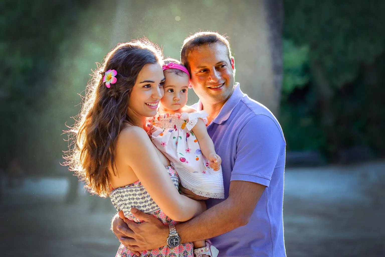 a man and woman holding a baby
